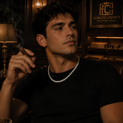 Man wearing a black shirt and diamond necklace in a dimly lit room wearing Moissanite tennis necklace in S925 sterling silver with platinum finish, featuring a continuous row of round stones displayed on black textured surface with Forged Crown branding
