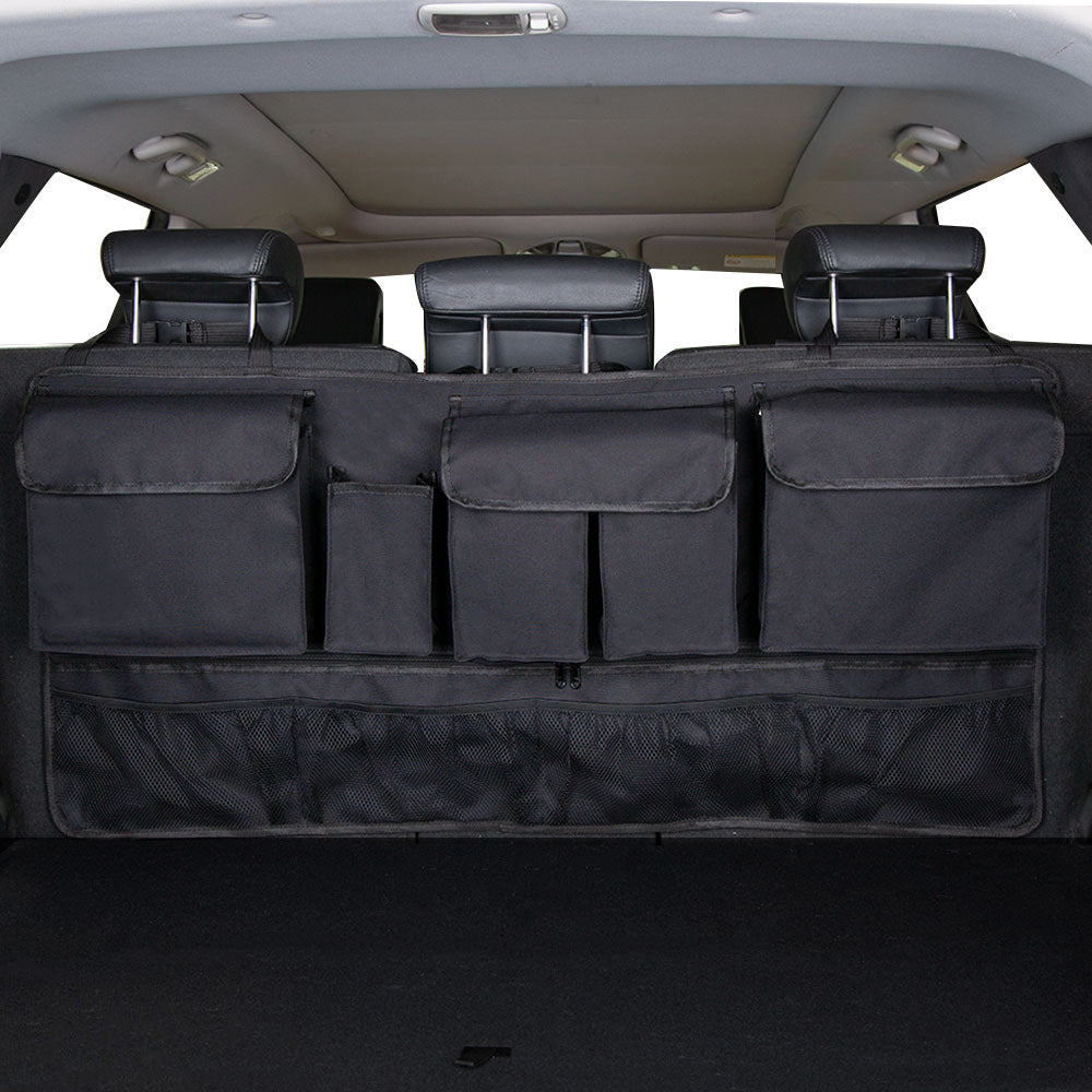Vehicle trunk with a rear seat hanging storage organizer with multiple compartments