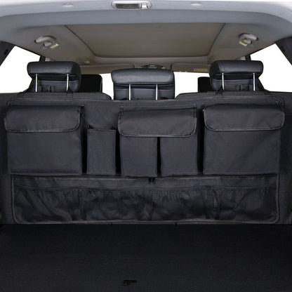 Vehicle trunk with a rear seat hanging storage organizer with multiple compartments