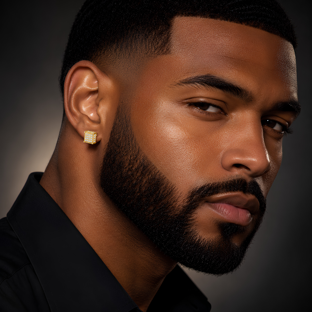 Close-up of a man wearing a gold luxury cube stud earring with pave moissanite against a dark background