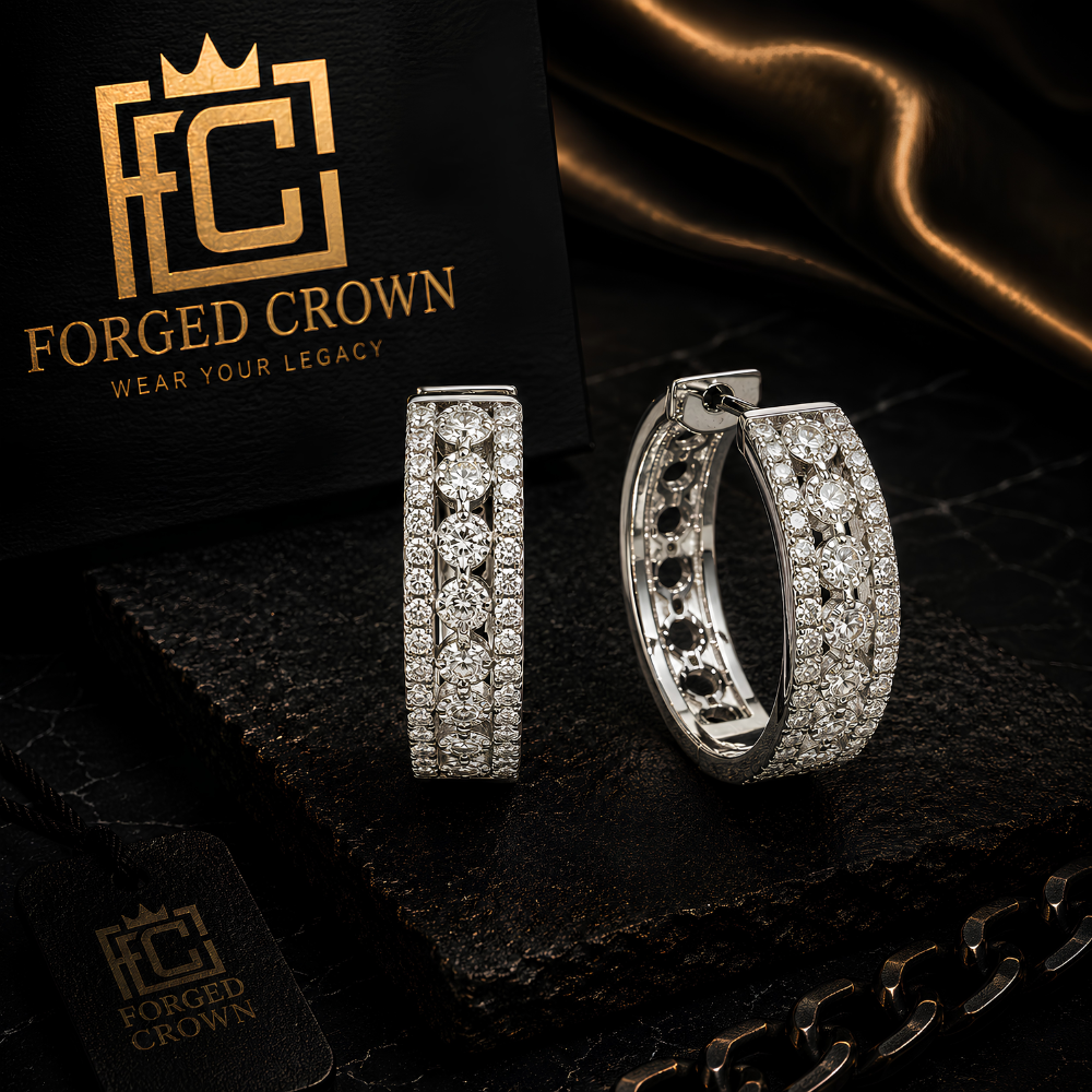 Silver hoop earrings with embedded stones on a dark surface with 'Forged Crown' branding. 20mm moissanite huggie hoops in platinum, gold, and rose gold finishes.