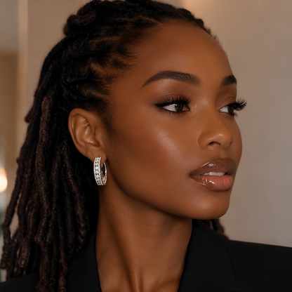 Woman with locs wearing 20mm platinum‑plated S925 moissanite hoop earrings with three‑row pave setting