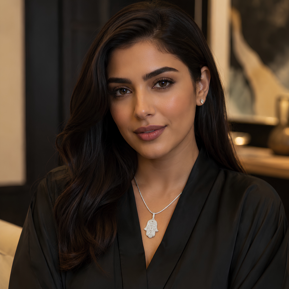 Woman wearing a black outfit with a Moissanite pave hand pendant in S925 sterling silver with platinum finish featuring dense stone setting 

