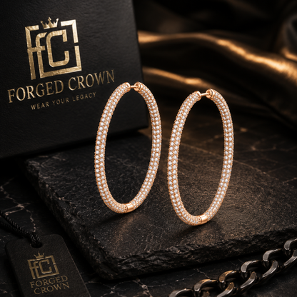 Gold round moissanite hoop earrings in S925 sterling silver with full surface sparkle and hinged closure on a dark surface with 'Forged Crown' branding