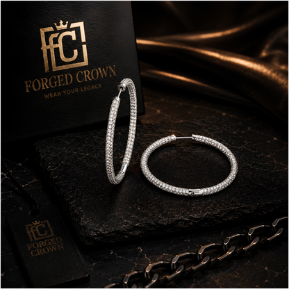 Close up of pave moissanite hoop earrings in silver with secure clasp on a dark surface with 'Forged Crown' branding.