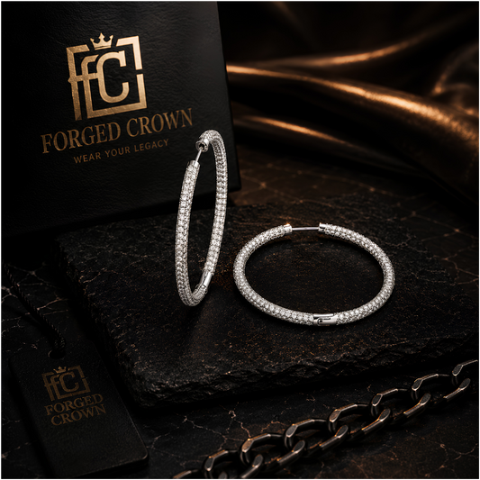 Close up of pave moissanite hoop earrings in silver with secure clasp on a dark surface with 'Forged Crown' branding.