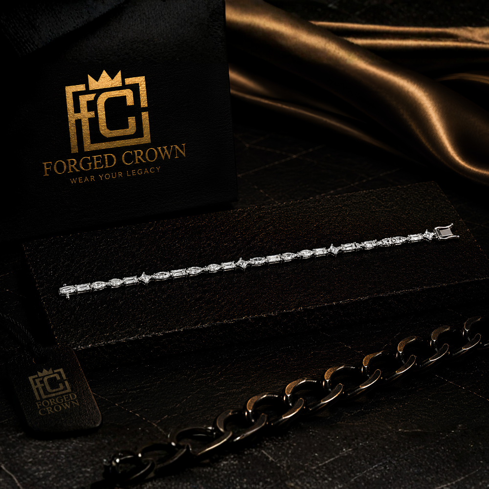 Moissanite mixed cut tennis bracelet in S925 sterling silver with platinum finish, displayed on textured black slab with Forged Crown 