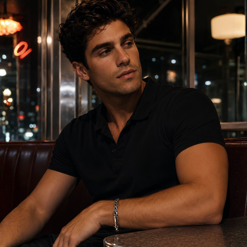 Man sitting in a dimly lit bar or restaurant wearing S925 sterling silver rope chain bracelet with bolt clasp featuring thick twisted link design and heavy structured form by Forged Crown
